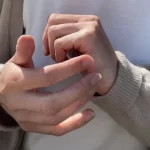 Close-up of EFT tapping on the side of the hand to release emotional blocks